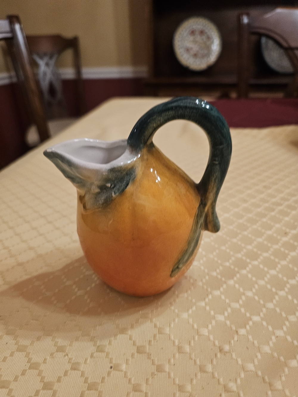 Handcrafted Orange Ceramic Pear Creamer with Green Handle - Small Chip In Rim